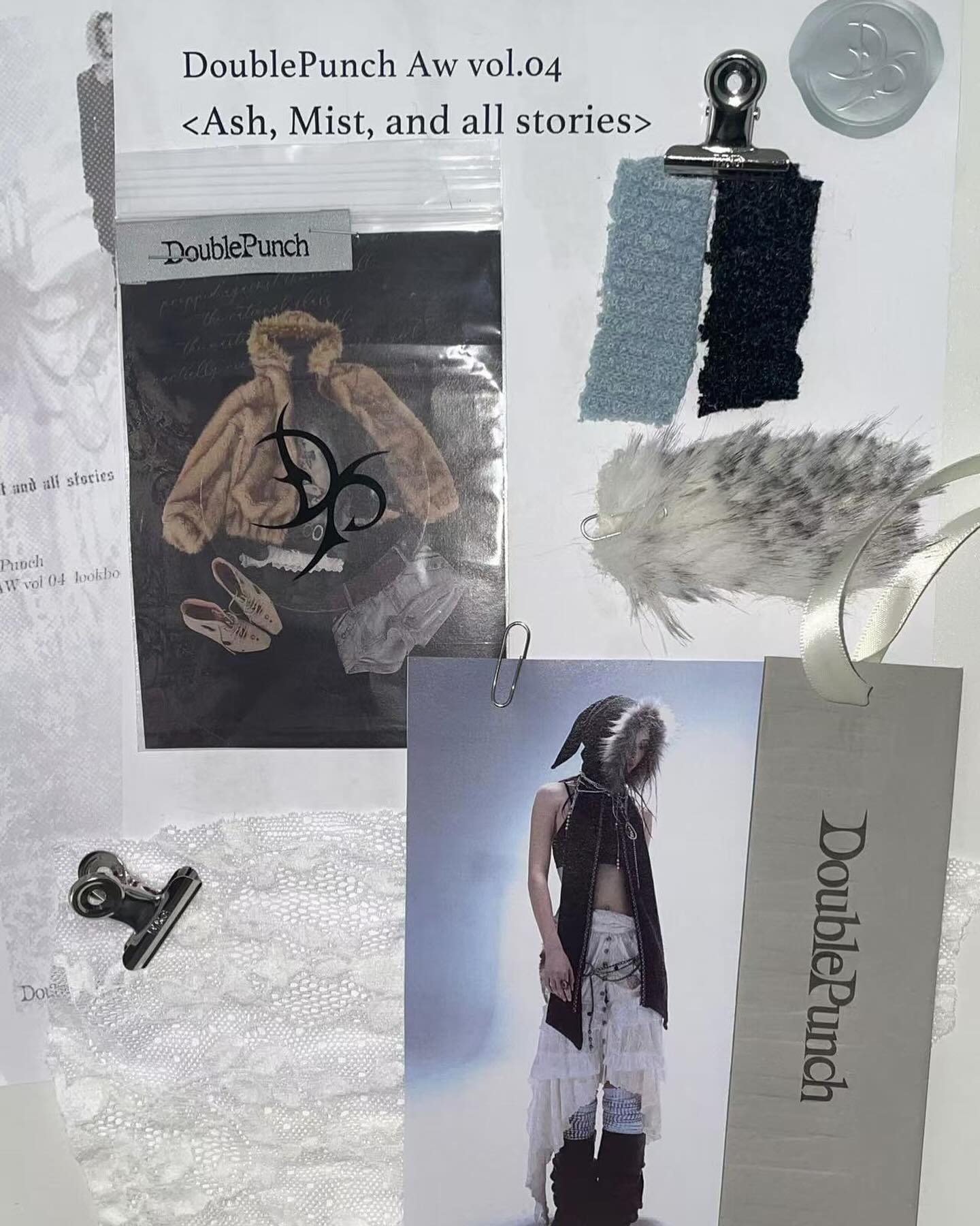 he image is a mood board or design inspiration board for a fashion collection likely named "doublepunch aw vol.04" themed around "ash, mist, and all stories".  it features various fabric swatches in shades of grey, blue, and black, some with a fuzzy or furlike texture. there are also images of clothing items, including a beige jacket, and a model wearing a long layered outfit in earth tones.  lace fabric and other smaller elements are included, along with tags and labels bearing the brand name "doublepunch." the overall aesthetic is dark, moody, and potentially winterthemed.