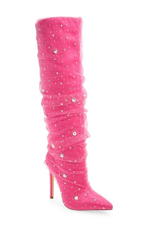 a hot pink, rhinestonestudded kneehigh stiletto boot is displayed against a white background. the boot is constructed of ruched fabric and adorned with sparkly gems.