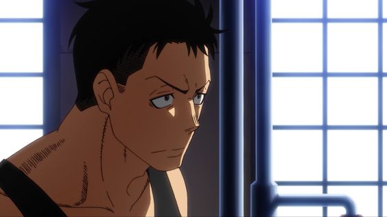 the image shows the face and upper torso of a muscular man with short black hair. he appears concerned or serious. he is in a room that is lit with cool indoor lighting. the image is a closeup perspective.