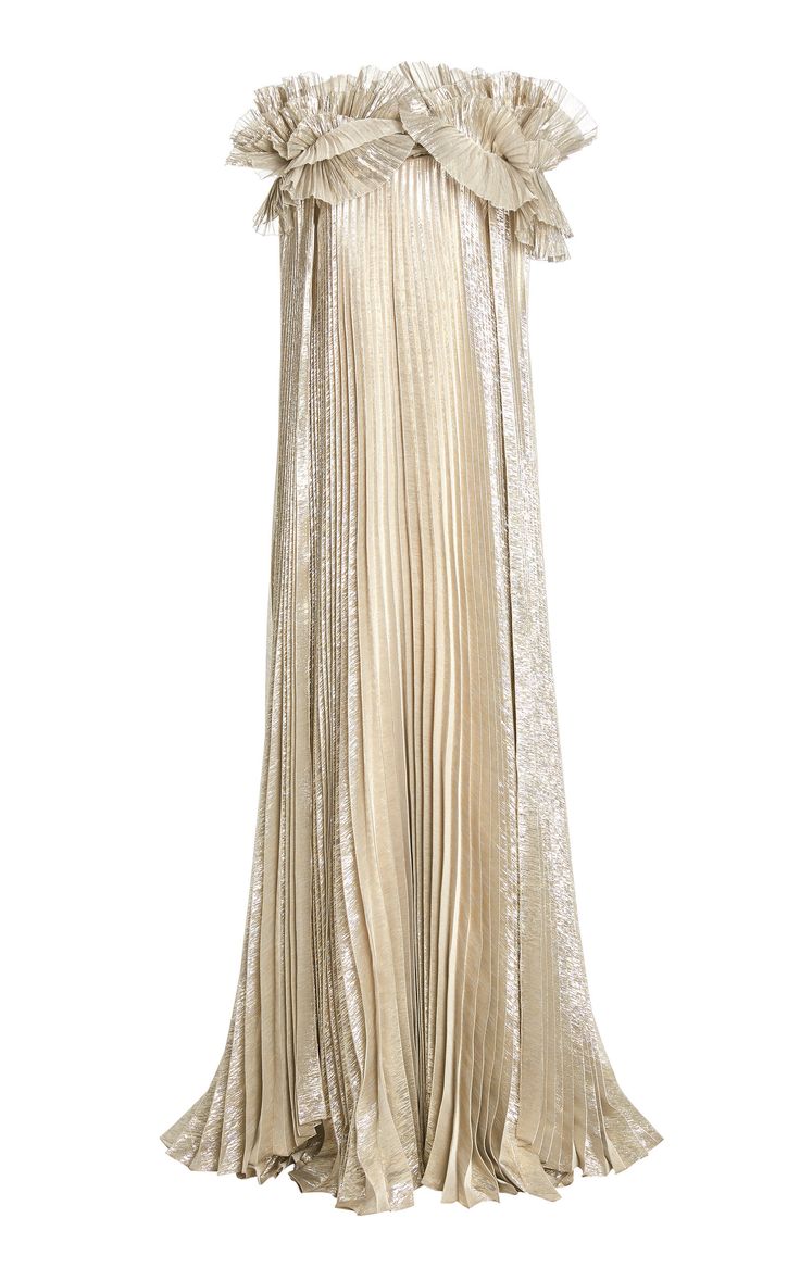 a long, gold, pleated gown with ruffle detailing at the top.