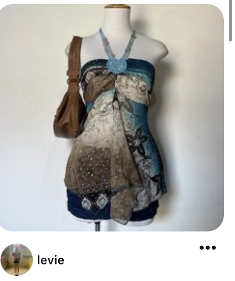 a blue, brown, and white patterned halter top and matching skirt set displayed on a mannequin. the top is tied in the front and has a beaded neckline. a brown leather purse hangs on the mannequin's left shoulder. the background is a plain white wall.