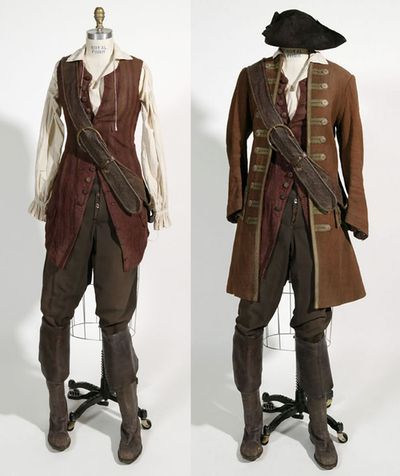 this image shows two men in periodstyle pirate costumes. both are wearing long brown jackets with gold buttons, brown vests with a belt and buckle, brown pants, and brown boots. the man on the left is wearing a white shirt, while the man on the right is wearing a brown shirt. the man on the right is also wearing a brown hat. the costumes are detailed and wellcrafted, and the men are posed in a way that shows off their attire. the background is a plain white wall, which helps to focus attention on the costumes.