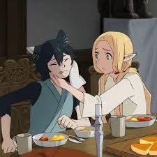 he image depicts an animestyle scene of two female characters. one has blonde hair, elflike ears, and is wearing a white, loosefitting outfit. the other has black hair with catlike ears and is wearing a dark blue kimonostyle garment. they are seated at a wooden table, eating breakfast together. the blonde girl is affectionately touching the other girl's face, suggesting a close relationship. the overall atmosphere is calm and intimate.  the setting appears to be an interior, possibly a dining room or kitchen.  the art style is reminiscent of modern anime, with softer lines and muted colors.