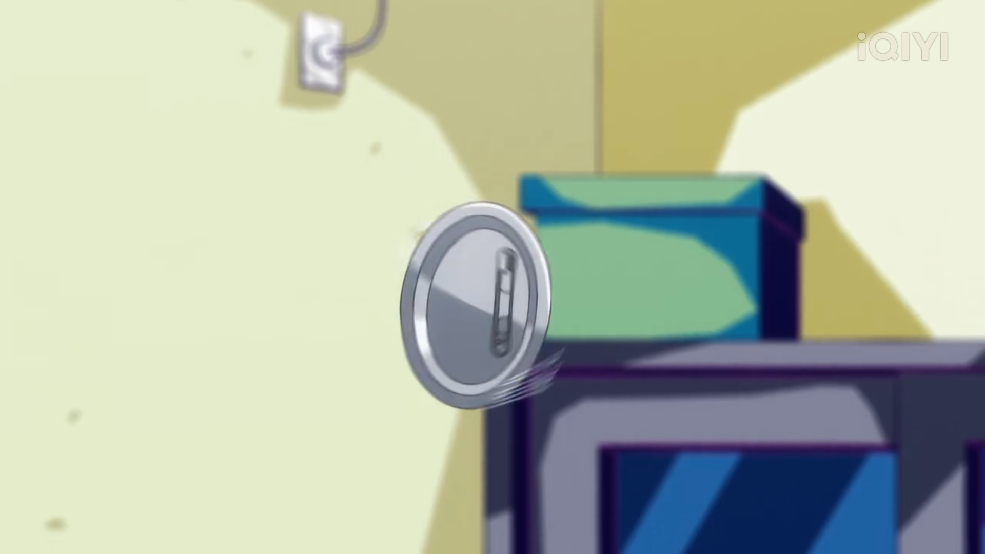 this is a cartoon image of a round mirror with a small handle attached to it, seemingly floating in midair. the setting appears to be a room with yellow walls, a television, and a teal box placed on top of it.