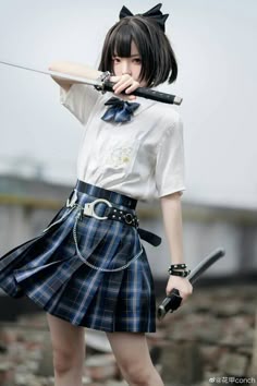 a japanese school girl cosplayer in a white shirt, black bow, plaid skirt, and black belt holds a katana and poses for the camera.