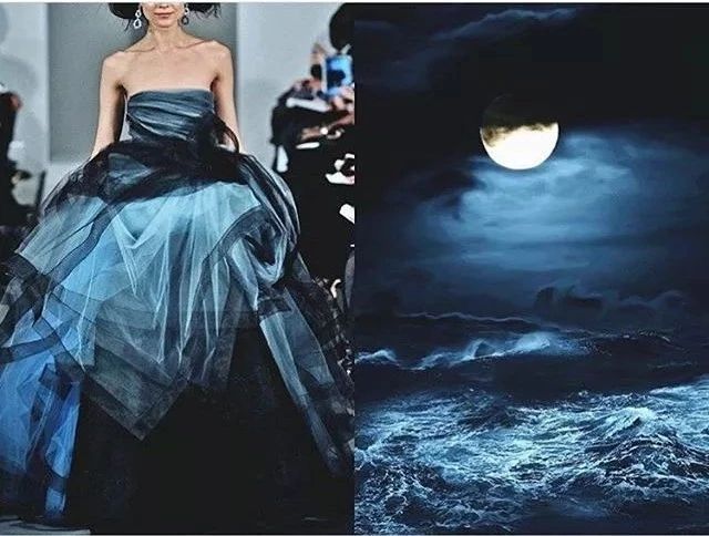 a woman in a beautiful blue and black dress stands against a backdrop of a stormy night sea with a large moon in the sky. she looks elegant and dreamy, and the image is full of romanticism.