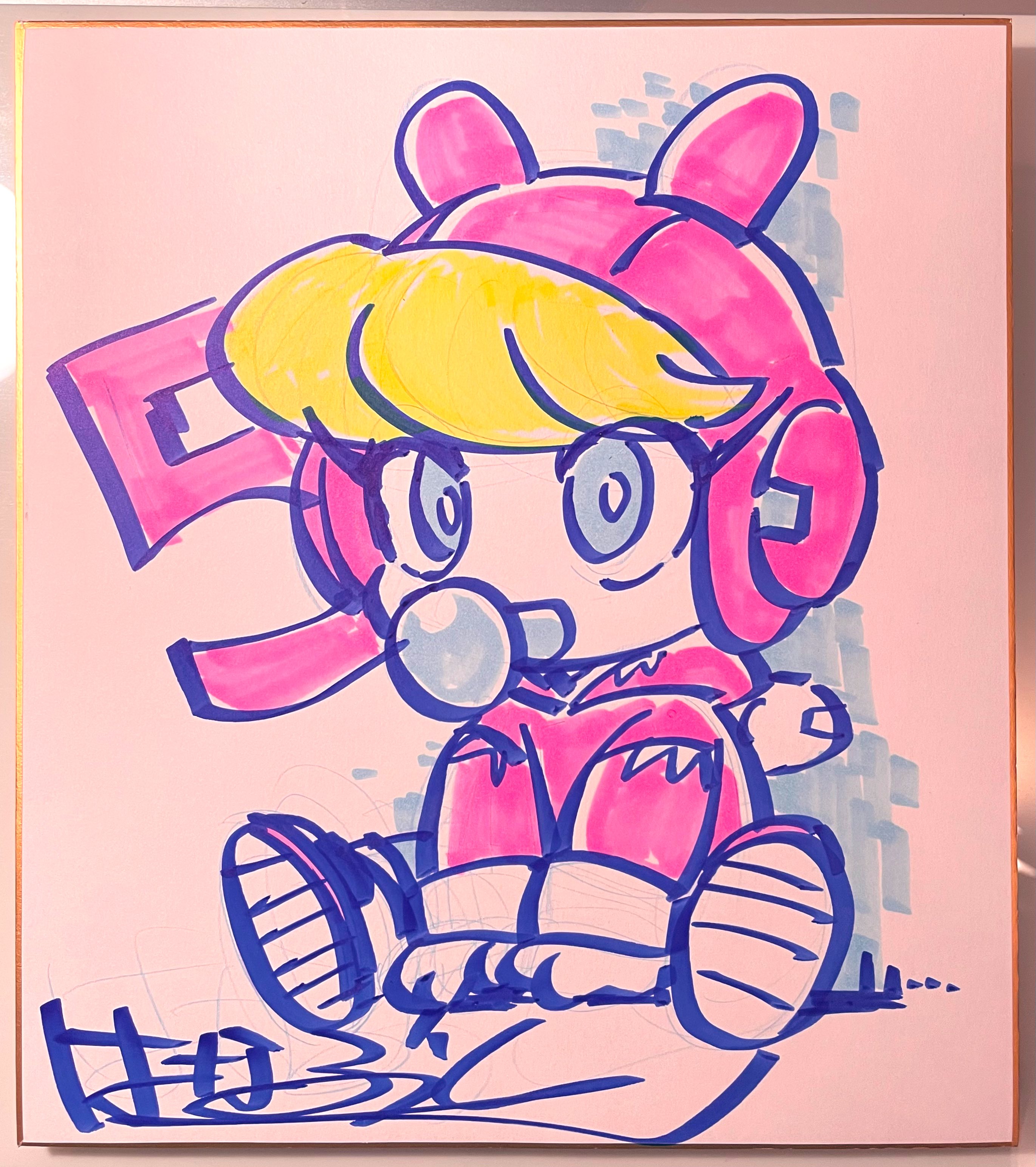 it's an illustration of a girl with yellow hair and blue eyes. she is wearing a pink bunny hoodie and white shoes.  she's sitting down with her legs spread and slightly turned to her right.  the background is plain white with a pink vertical rectangule behind her. the image appears to be a drawing made with blue and pink markers, with some yellow for the hair.  there is a signature in cursive writing on the bottom left of the image.