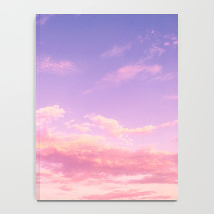 a cotton candycolored sky, awash in the soft hues of a setting sun. pink and purple clouds dominate the scene, their fluffy forms gently blending into one another. the scene evokes a sense of peace and tranquility.