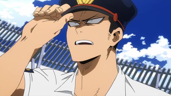 a closeup image of a man in a police uniform. he has a surprised and concerned expression on his face. the background suggests an urban environment with a fence and a blue sky with clouds.