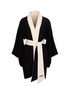 a black and white robe with long sleeves and a sash that is tied in a bow at the front. the robe is made of a soft and comfortable fabric and it is perfect for lounging around the house.