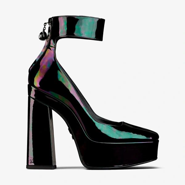 a single black patent leather platform high heel shoe with an ankle strap is displayed against a white background. the shoe has a thick heel and a platform sole. the patent leather has an iridescent sheen, reflecting green and purple hues. the ankle strap has a small, dark charm hanging from the back.
