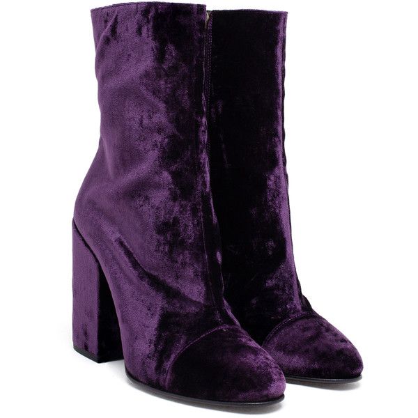 a pair of women's ankle boots made of rich purple velvet are shown.  the boots feature a block heel and a slightly pointed toe. they are shown on a white background.  the boots appear to be new and unworn.