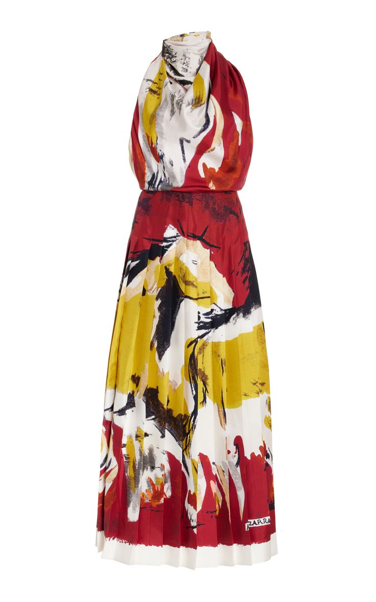 a red, white, and yellow printed, halter, pleated dress. the dress is a knee length. the halter strap is tied at the neck. the fabric looks like silk or satin. the dress is very stylish and can be worn for a variety of occasions, from a casual day out to a special event.