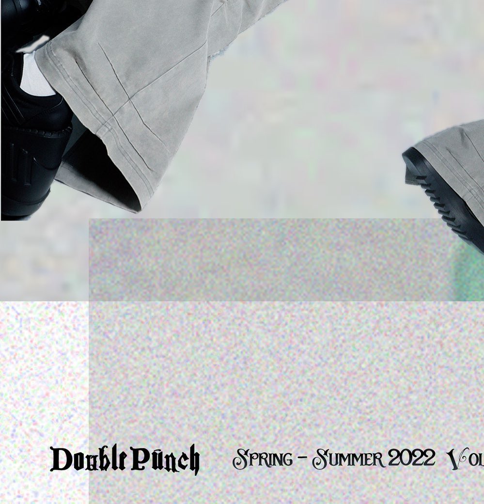 the image is a fashion catalog spread featuring the "double punch" spring/summer 2022 collection. it shows closeup shots of a model's legs wearing grey baggy pants and black sneakers. the pants are cuffed at the ankles. the background is a light, grainy texture with muted colors. the text "double punch spring  summer 2022 vol" is displayed at the bottom, indicating the brand and season.  the overall aesthetic leans towards streetwear fashion.