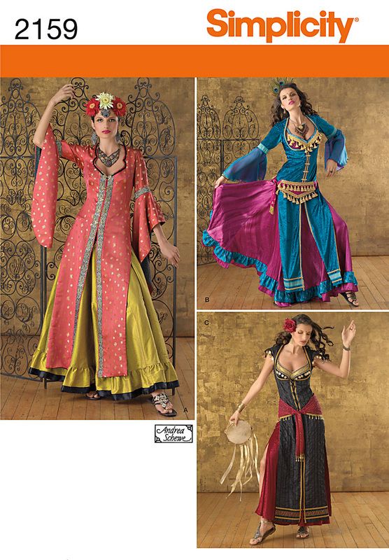 the image is a simplicity sewing pattern cover, number 2159, featuring three different variations of a gypsyinspired costume. the first costume consists of a long, openfront gown with bell sleeves, worn over a contrasting long skirt. the model wears a floral headband and ornate necklace. the second costume is a blue and pink layered dress with bell sleeves and an embellished bodice and belt. the third costume includes a black corset top with gold trim, worn over a long skirt with a high slit and a red sash. the model is holding a tambourine.