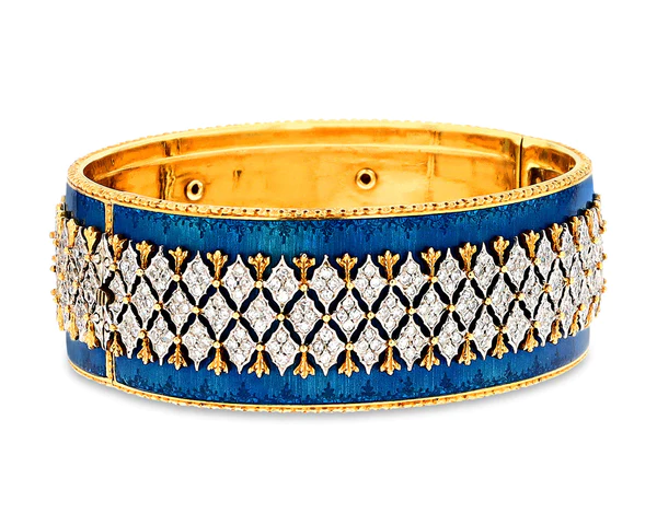 the image showcases a wide gold bangle adorned with a central band of diamonds meticulously arranged in a repeating geometric pattern. this dazzling diamond band is bordered by a vibrant blue enamel, further accentuated by a gold trim. the bangle's interior is lined with gleaming gold.