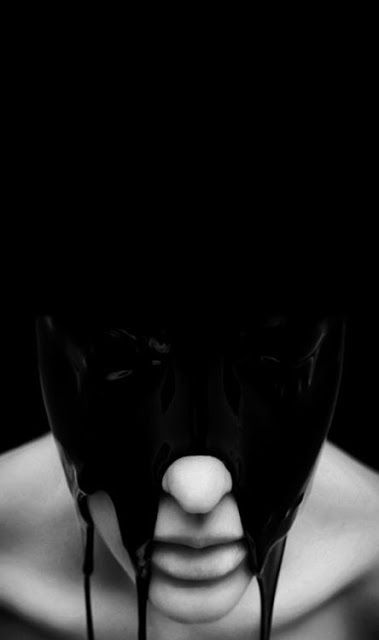 a close up black and white portrait of a woman with black paint dripping down her face. the woman is looking at the camera with a mysterious and dramatic expression. the image is dark and moody, creating a sense of intrigue and suspense.