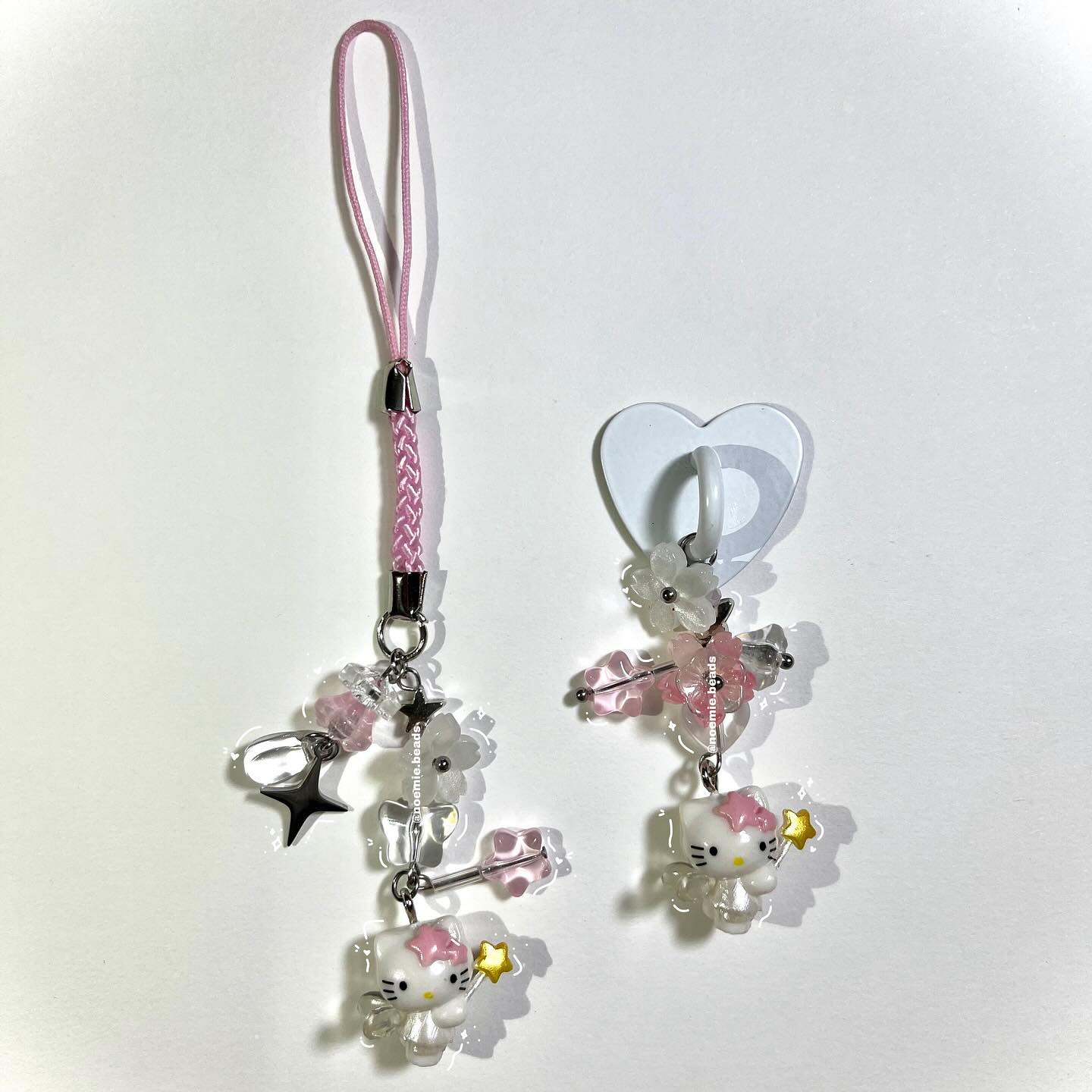 the image shows two handmade phone charms featuring hello kitty, beads, stars, and flowers. one charm has a pink braided strap, while the other hangs from a heartshaped hook. both charms include hello kitty figures and a mix of pink and white beads.