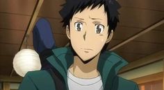 an anime character looking concerned about something. he is inside what looks like a home. he has short black hair and is wearing a white tshirt and a teal jacket. he has a black strap over his shoulder. the background is blurred, but you can see wooden walls and a light fixture.
