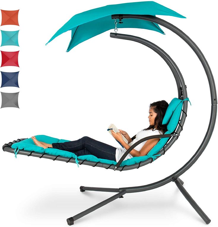 a woman is relaxing in a turquoise swing chair with a canopy, reading a book. the chair is made of a steel frame and has a comfortable cushion. it is designed for outdoor use on a patio or deck. different colored canopy options are shown on the left side.
