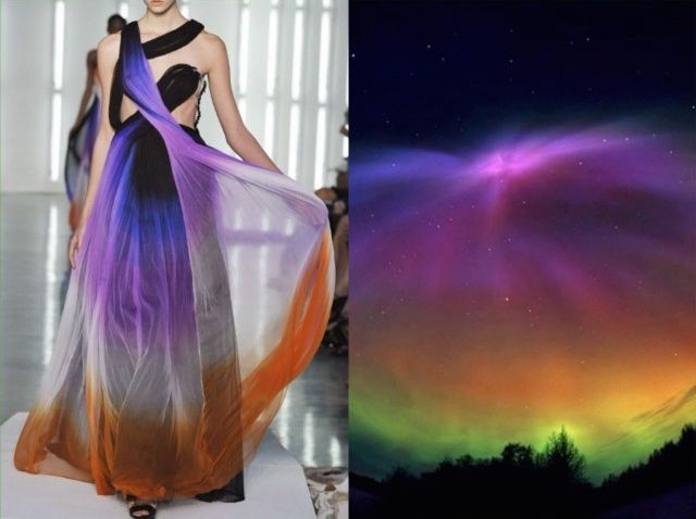 the image is a split image. on the left side, a model is wearing a colorful ombre gown on a runway. the gown has a black bodice and a flowing skirt that transitions from purple to orange. the model is posed with her left arm extended and her right hand on her hip. on the right side of the image, the aurora borealis is visible in the night sky. the colors of the aurora borealis closely resemble the colors of the gown.