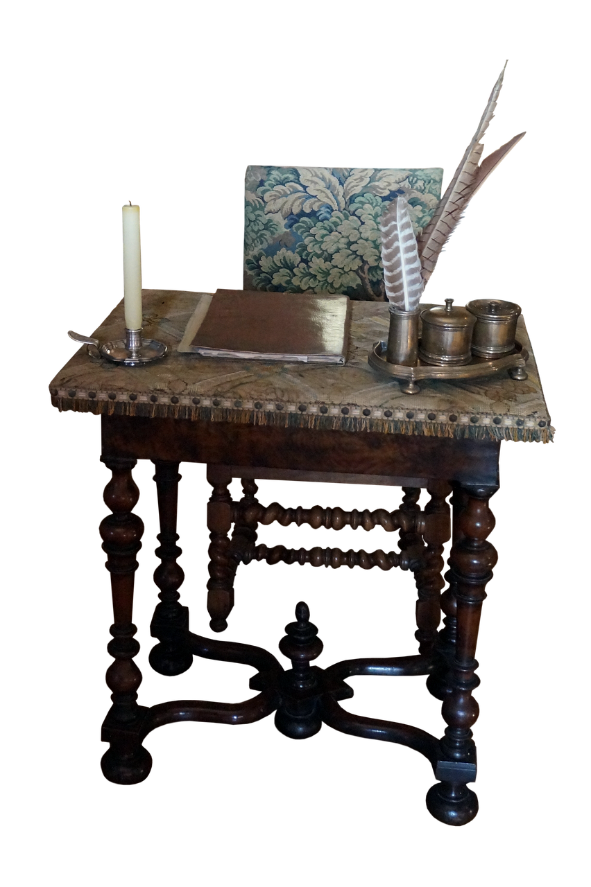 a writing desk with antique furniture sits against a black background. on the desk is a book, an inkwell with quills, and a lit candle in a silver candlestick. a chair with a tapestry backrest is behind the desk.