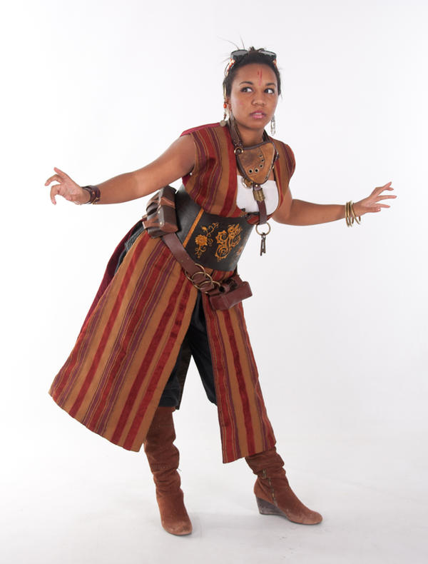 a fullbody shot of a woman in a steampunkinspired costume. she is wearing a long, striped coat over a corsetlike top and pants, paired with brown boots and various accessories. her expression is serious and focused, and her pose suggests movement or action.  the background is plain white.