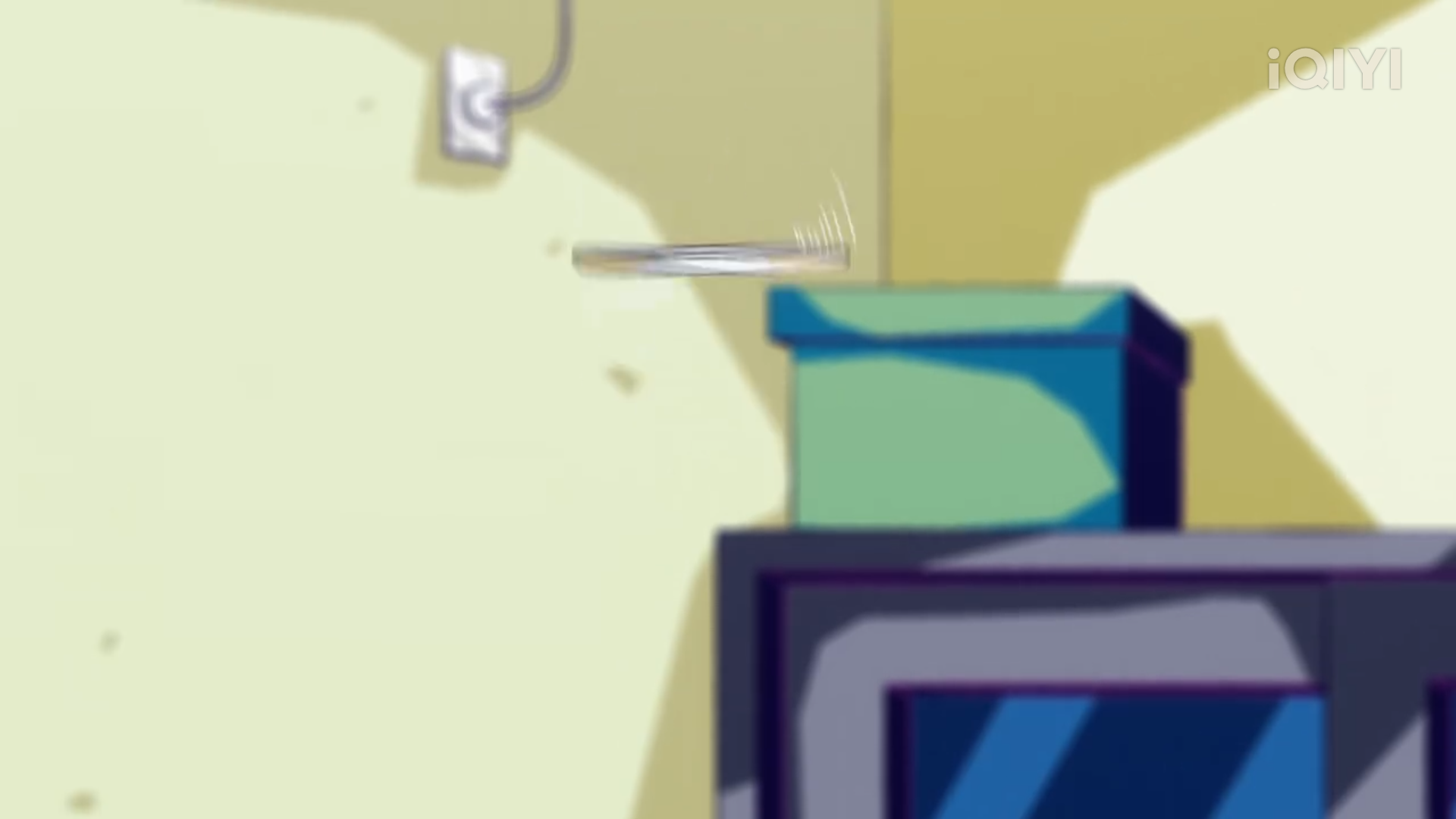 a cartoon image of a silver, metallic object hovering in midair above a teal box that is sitting on a shelf. the shelf is above a television, which is turned on, and a white cord is plugged into the wall. the walls are yellow.