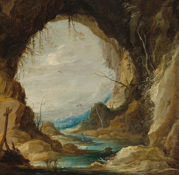 this is a painting of a landscape viewed from inside a cave. the cave opening frames a scene of water, a river or stream, with mountains in the distance under a cloudy sky. there are dead trees and other vegetation visible. to the left, a rough wooden cross stands. the painting style is reminiscent of classical landscapes. the scene depicts a rocky and somewhat desolate environment.