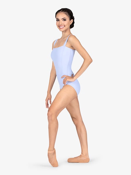 a young woman, possibly a ballet dancer, is shown in profile view.  she is smiling and wearing a light blue, squareneck leotard and light pink ballet shoes.  she is standing with a graceful posture, suggesting she is a trained dancer. the background is plain white, focusing the attention on the subject. the image is professional quality and seems to be from a dance apparel catalog or website.