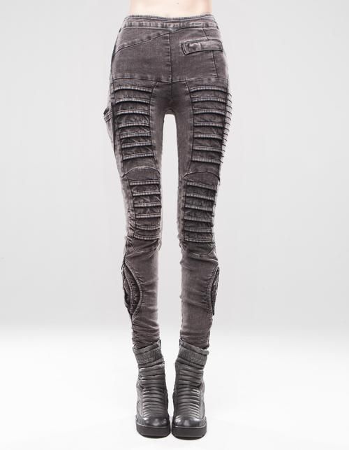 a front view full studio shot of a person wearing gray pleated denim pants with matching gray boots.