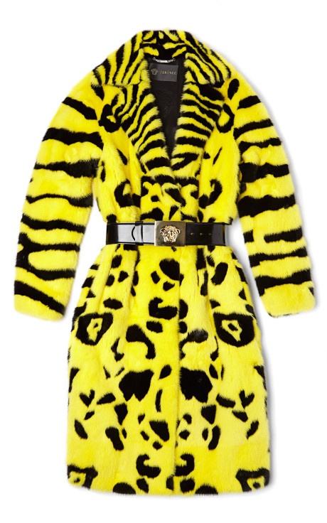 a yellow and black versace faux fur coat with an animal print and a belt.