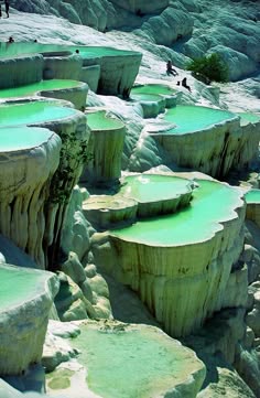 a panoramic view of the pamukkale travertine terraces in turkey. the white, calciumrich cliffs are layered with cascading pools of turquoise thermal water. the natural beauty of the landscape is breathtaking, showcasing the power of nature to create unique and stunning formations.