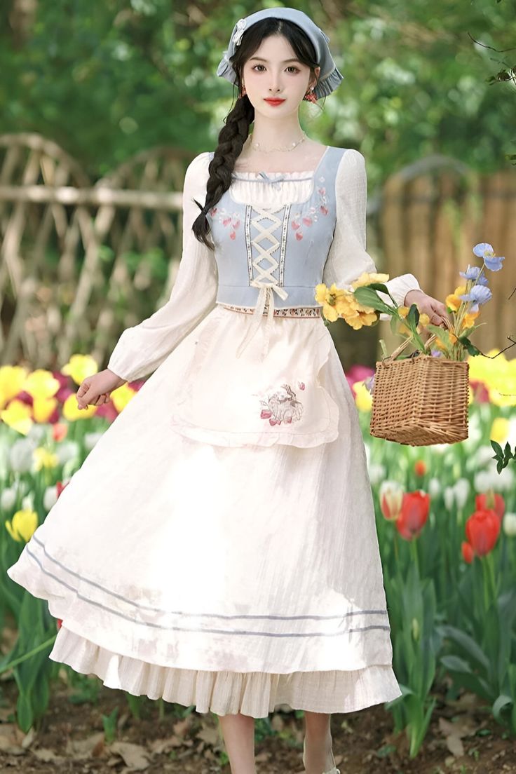 a young woman in a vintageinspired blue and white dress stands in a garden of yellow and red tulips. she's holding a wicker basket with yellow flowers in one hand, and her other hand is outstretched. her dress features delicate floral embroidery, a laceup bodice, and a flowing skirt. she's wearing a matching blue hat and has a bright, cheerful expression. the overall aesthetic is romantic, whimsical, and evocative of a fairytale or cottagecore style.