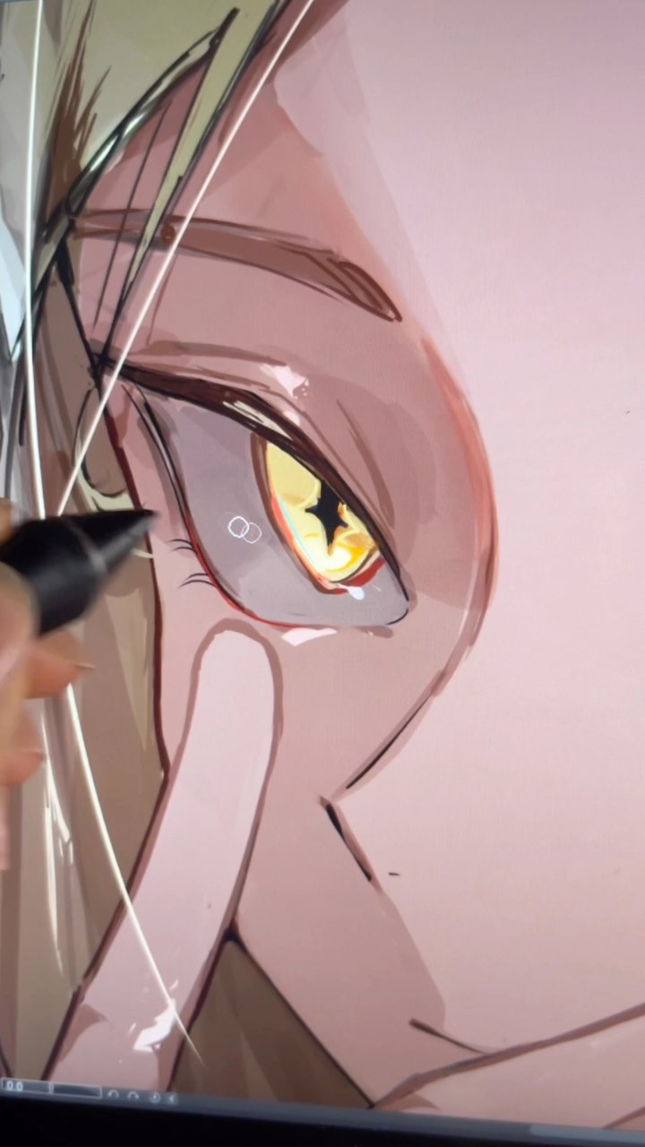 a closeup shot of a digital drawing in progress, showcasing a female anime character's eye with intense golden coloring.  the artist's hand is visible, holding a stylus on a graphic tablet.  the style is reminiscent of anime and manga, with soft shading and a focus on the character's expressive features.  the overall color palette is muted pinks and browns.