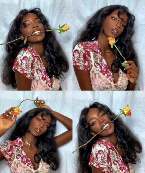 a collage of four portrait photos of a young, black woman with dark skin and black curly hair, she is wearing a red and pink floral dress. the woman is looking directly at the camera and holding a rose in each picture.