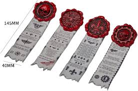 the image shows four white ribbons with red wax seals. the ribbons are about 145 mm long and 40 mm wide. the wax seals have different designs, including a skull, an eagle, a fleurdelis, and a gear. the ribbons and seals appear to be awards or certificates.