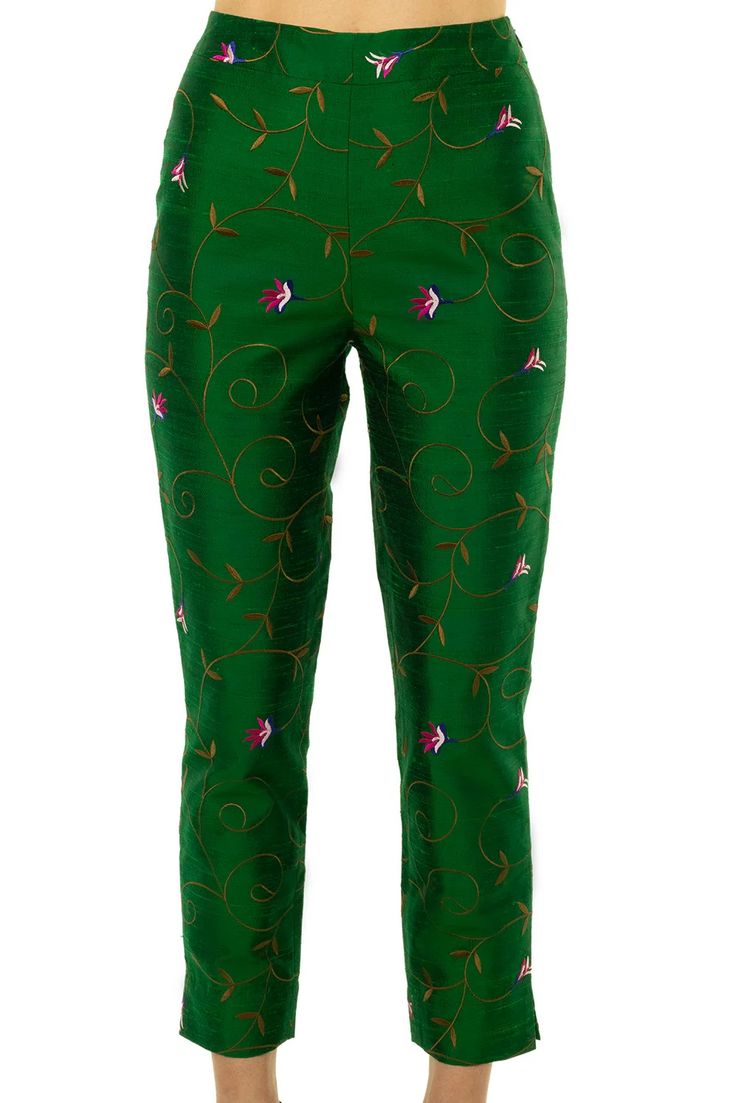 a pair of green cropped pants with a floral embroidery pattern. the pants are made of a silk fabric and have a fitted silhouette. the embroidery is in shades of gold, pink, and blue.