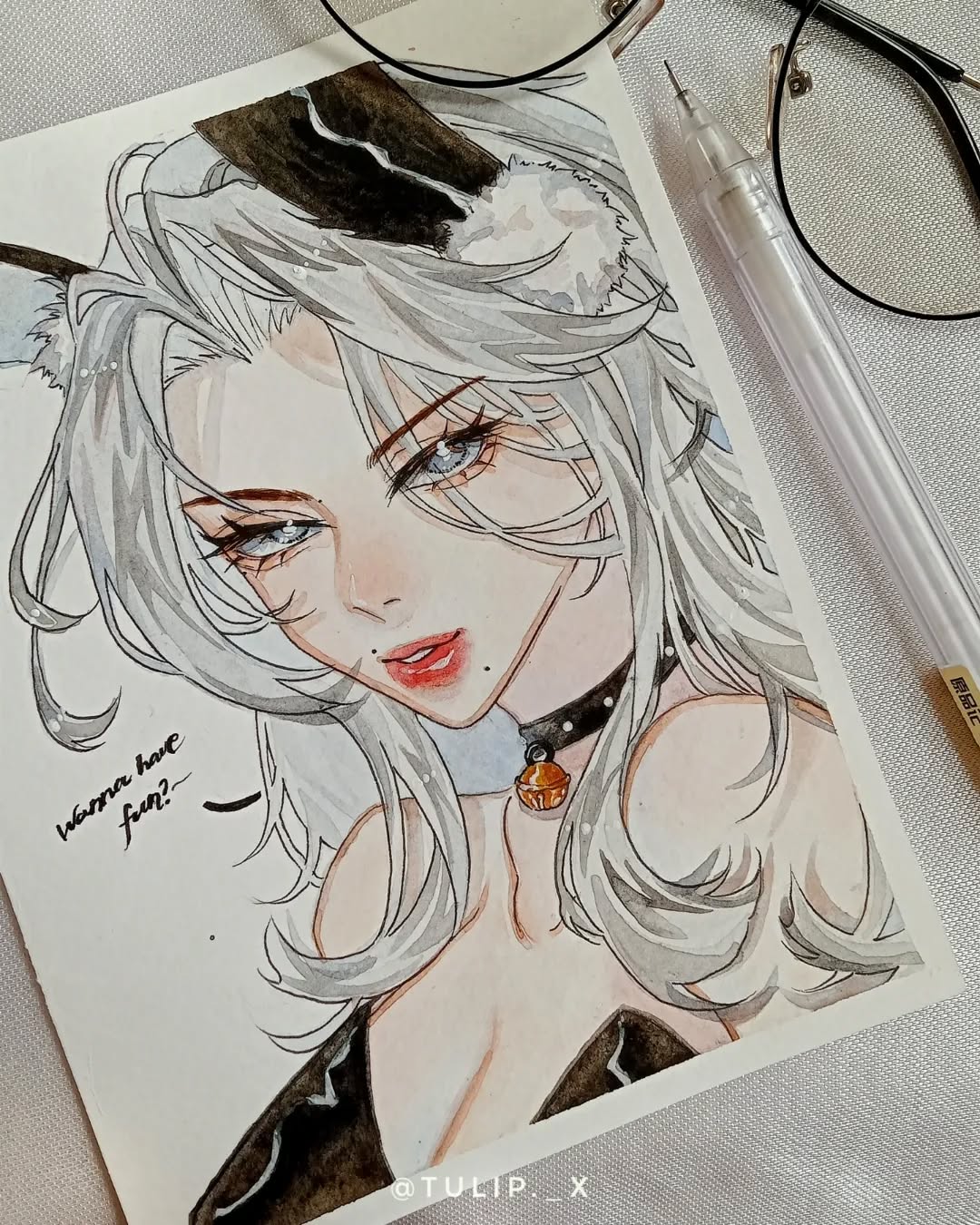 closeup view of a watercolor painting depicting an animestyle girl with long, flowing white hair and cat ears. she has a delicate face with expressive eyes and is wearing a black choker with a small bell. the style is soft and detailed, with subtle shading and color blending to create a dreamy atmosphere. the artist's signature "@tulip_x" is visible in the bottom right corner.  a portion of eyeglasses and a pen are visible in the upper right corner, suggesting the artist's workspace. the background is a plain, offwhite surface.  the painting is framed by a white paper.  a handwritten message "wanna have fun?" is visible on the left side of the drawing.