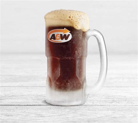 a closeup shot of an a&w root beer float in a frosty mug. the mug is filled with a dark brown root beer topped with a thick layer of creamy foam. the mug has the iconic a&w logo on it. it is sitting on a white wooden surface. the drink is ice cold and refreshing, perfect for a hot day.
