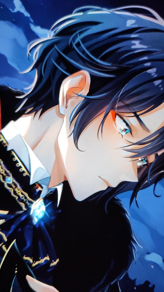 the image is a closeup digital drawing of an animestyle young man. he has dark blue hair that partially covers his face. his eyes are a striking light blue, and his expression appears to be one of sadness or melancholy. he is wearing an elegant dark outfit with a white collar and a noticeable jewel or pendant at his chest. the background is dark and moody, with shades of blue and black, which contrasts with the brighter tones of his skin and eyes. the overall style is dramatic and somewhat mysterious. the level of detail in the art is high, indicating professional or advanced artistic skill.