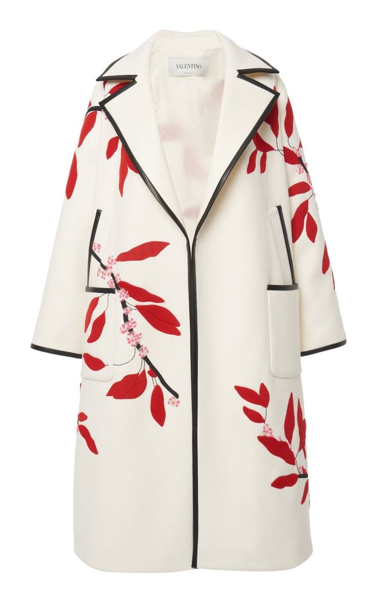 a white coat with red leaves and branches print. the coat has a collared, openfront design with black trim and pockets. the brand is valentino.