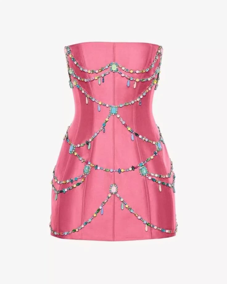 a strapless, formfitting pink mini dress is displayed on a plain white background. the dress is adorned with multiple strands of colorful beads and jewel embellishments that drape across the bodice and skirt in a garlandlike fashion. the embellishments include larger jewel accents spaced along the strands, with smaller beads in various colors strung between them. the dress appears to be made of a smooth, possibly satinlike fabric, and has a defined waistline and slightly flared skirt.