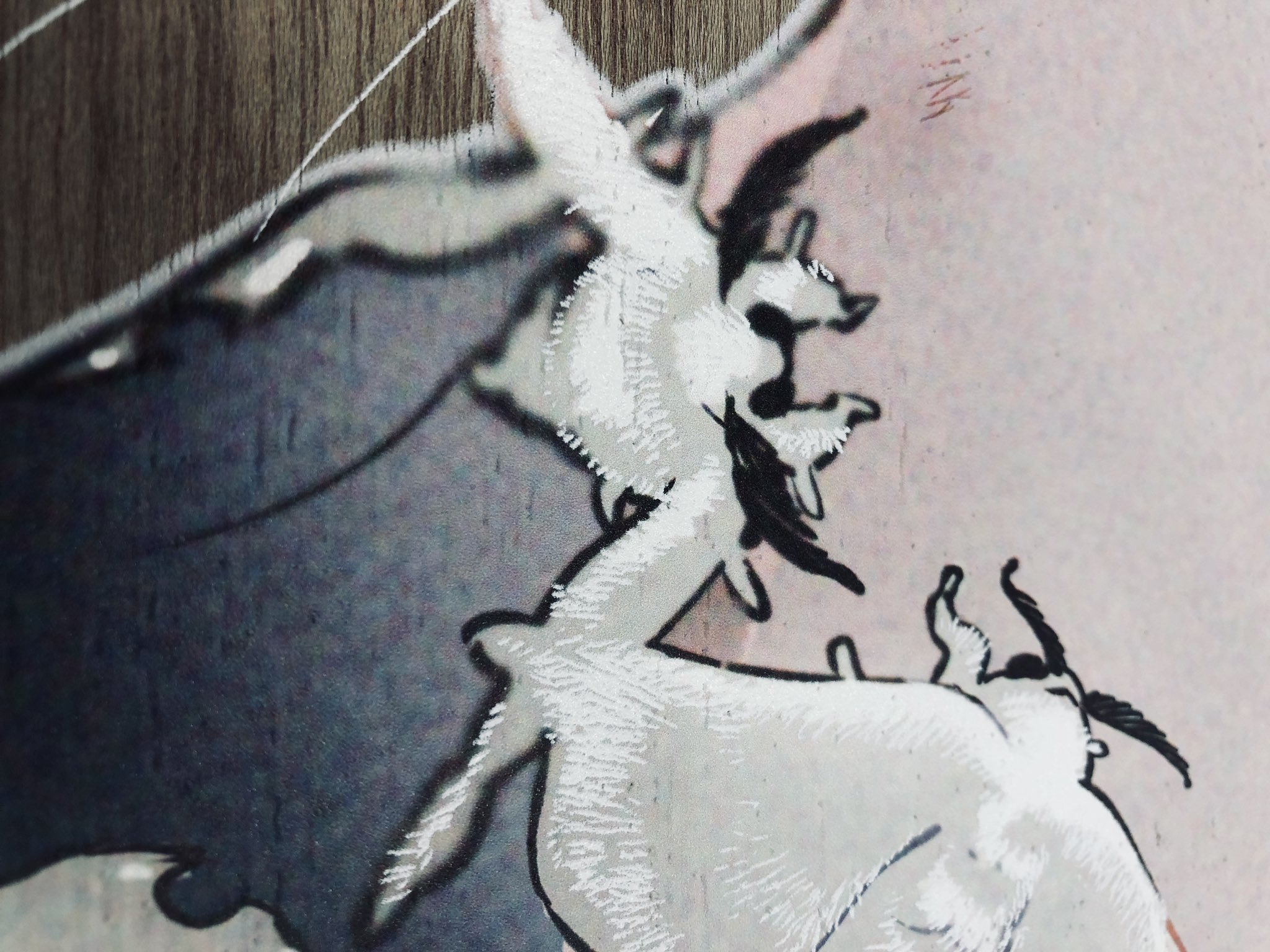 the image shows a painting of two white goats in a dynamic pose. the painting uses a combination of blue, gray, white and black. the background is a mix of beige and gray.  the texture of the painting suggests it might be on wood.