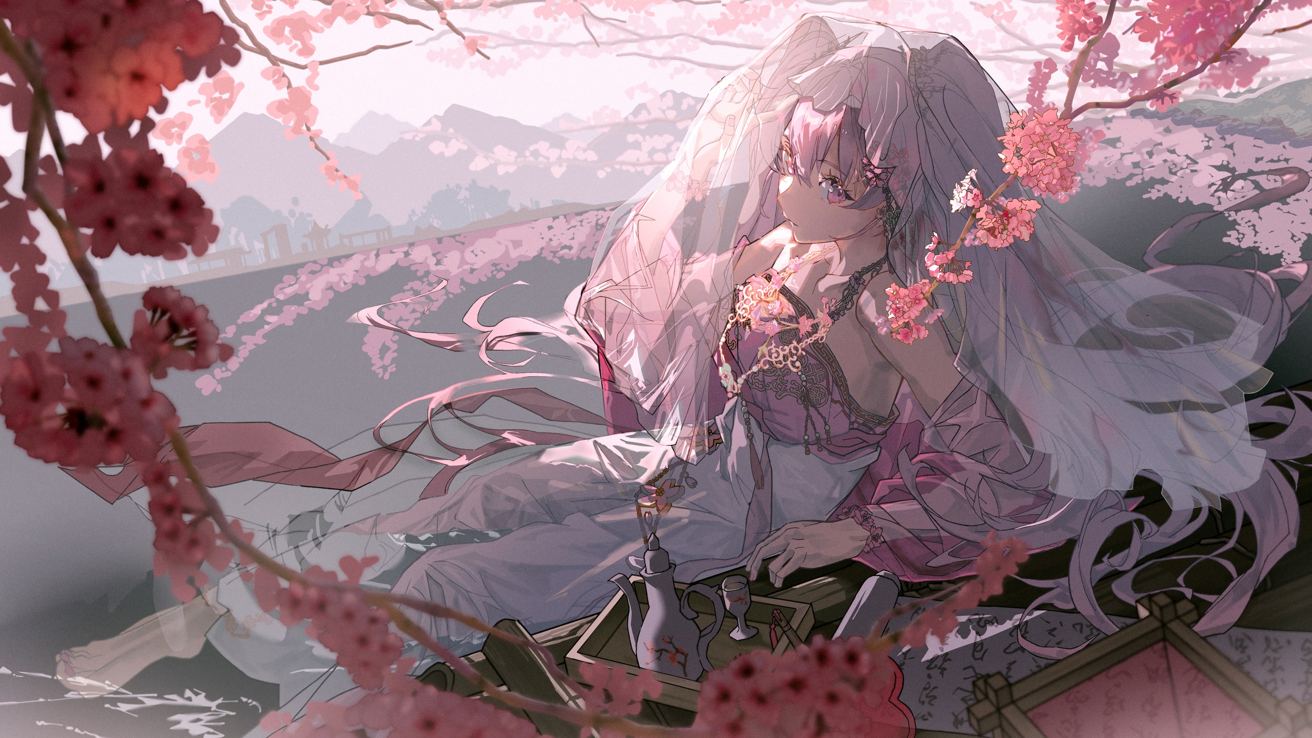 an anime girl with pink hair and a veil sits among cherry blossoms. she wears a pink dress and is surrounded by flowered branches. a tea set sits on a wooden tray in front of her. in the background is a landscape with mountains.