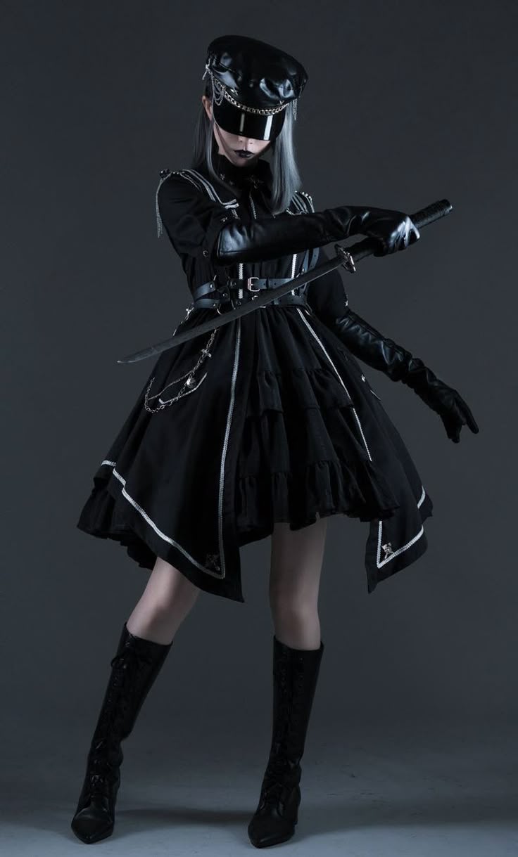 a woman dressed in a gothic lolita style cosplay outfit with a dark aesthetic. she is wearing a black dress with silver accents, a black hat with a visor, black boots, and long black gloves. she is also wearing a belt with chains and holding a sword. the dress has an asymmetric hem. the background is a dark grey.
