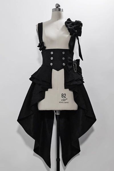 a black dress is displayed on a mannequin. the dress has a high waist with buttons and a bow on the shoulder. the skirt of the dress is long and flowing.