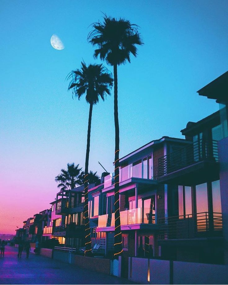a vibrant scene of palm trees silhouetted against a pastel pink and blue sunset sky. the crescent moon hangs high in the sky, casting a gentle glow over the beach houses lining the coastline. the architecture features balconies, large windows, and balconies, hinting at luxurious and comfortable beachside living. the warm colors of the sunset illuminate the buildings, making the image feel both tranquil and inviting, a perfect representation of a tropical getaway.