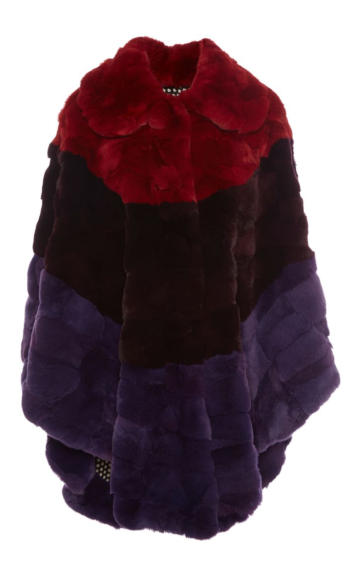a multicolor fur coat is displayed on a white background. the coat is primarily composed of red, brown, and purple fur sections arranged horizontally. the upper part, around the collar, is red, followed by a brown section in the middle, and the lower part is purple. the coat appears soft and textured, indicative of fur. the arrangement of colors gives the coat a distinct and bold pattern.