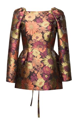 a floral dress with long sleeves and ties at the bottom. the dress has a scoop neck and a colorful floral pattern.